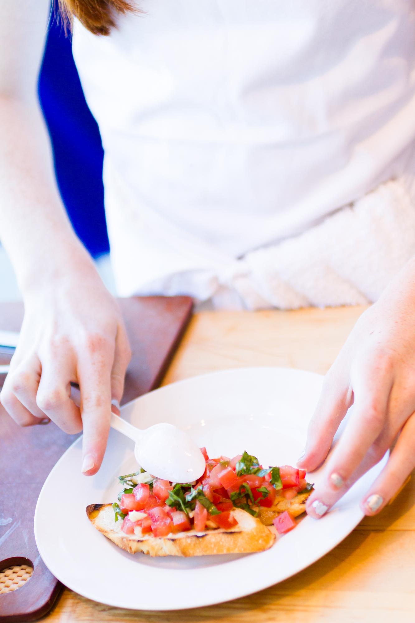 Chef plating a seasonal dish in a small kitchen
